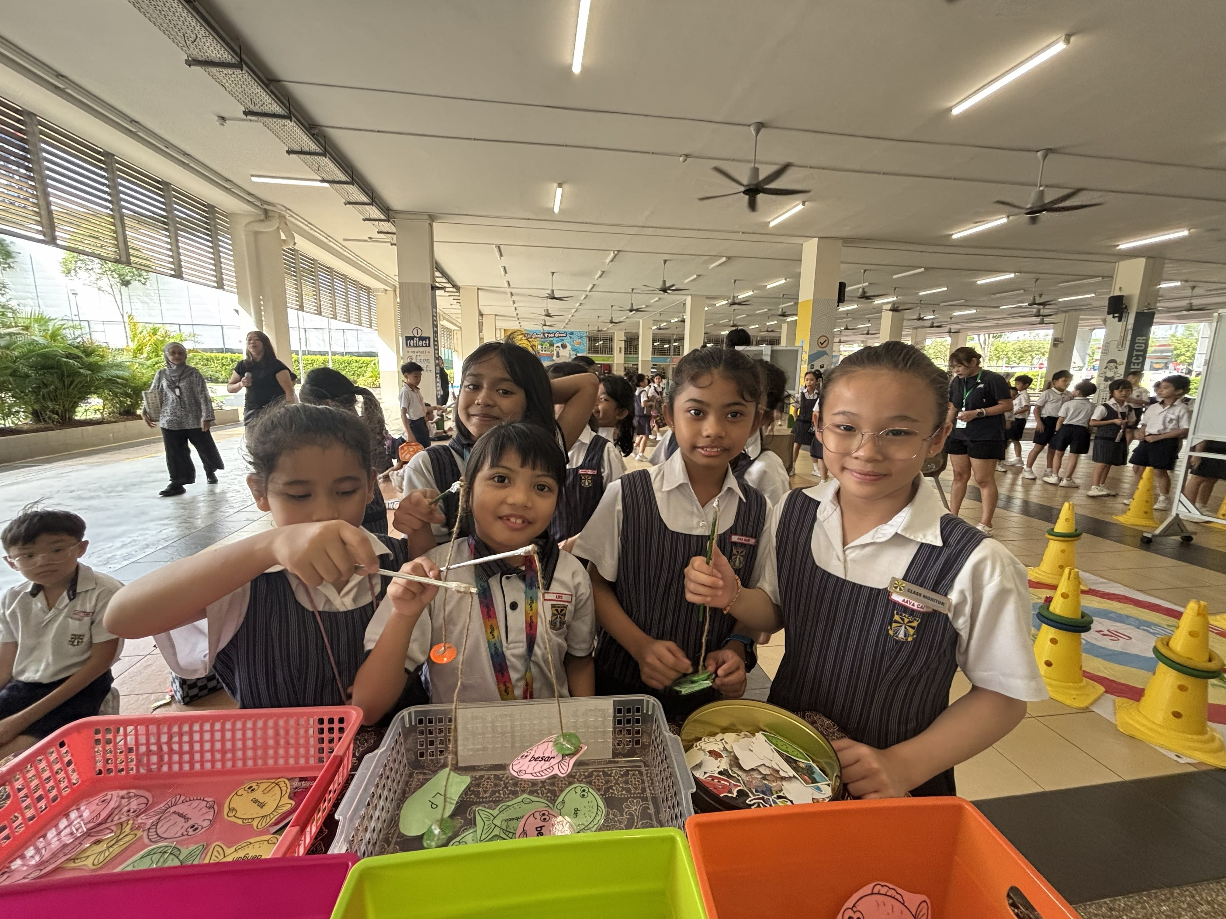 Students engaging in interactive Malay language games during recess.